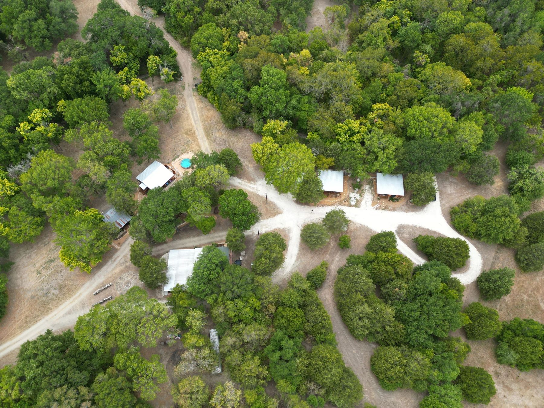 Aerial view of AVA Retreat's cabins and pavilions in the trees